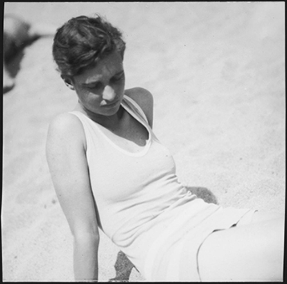 Half-length portrait of Annemarie Schwarzenbach sitting on the beach
